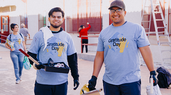 Gratitude Day volunteers with children in yellow shirts